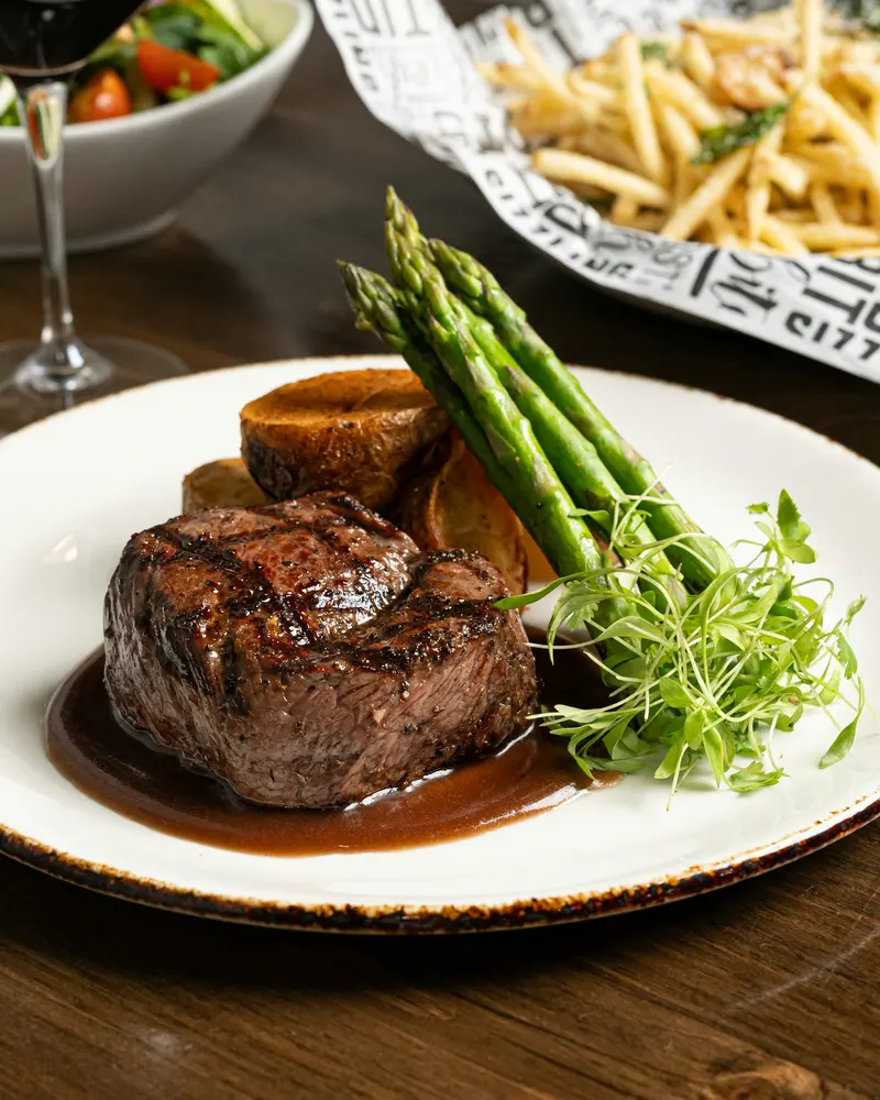 Pavé de bœuf, asperges et verre de vin rouge